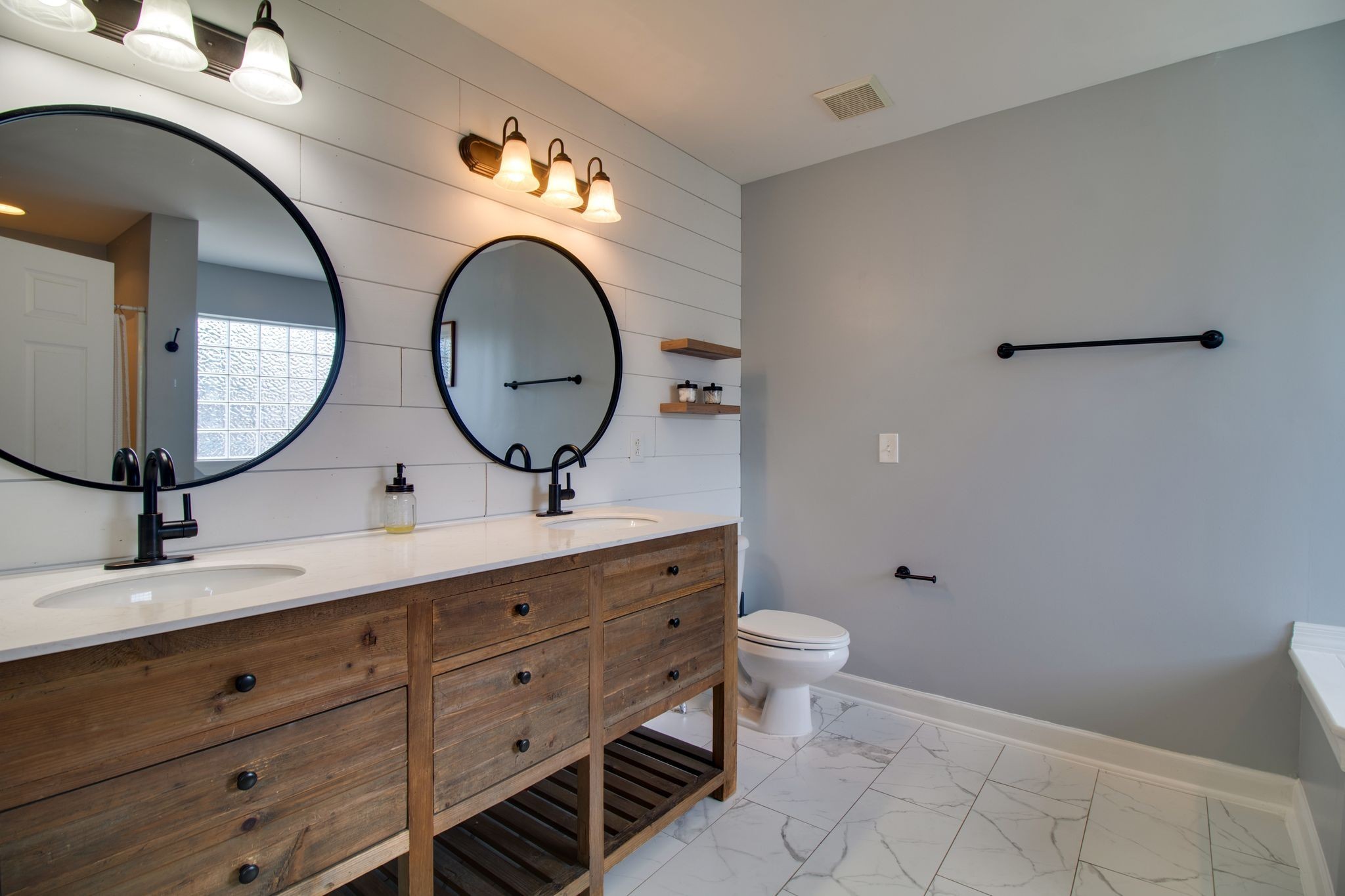 1334 Davy Crockett Drive Murfreesboro, TN 37129 - Photo 25 of 45 a bathroom with a toilet a sink and mirror