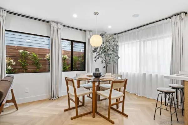 a dining room with furniture and window