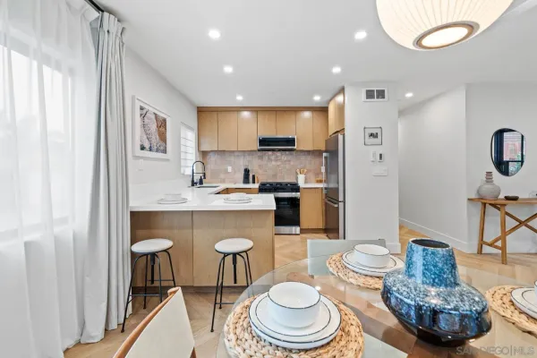 a kitchen with a dining table and chairs