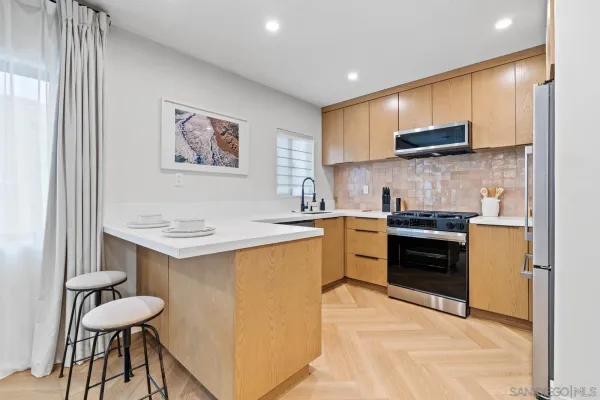 a kitchen with a sink cabinets and stainless steel appliances