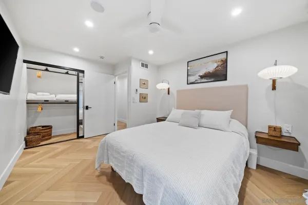 a bedroom with a bed and a lamp