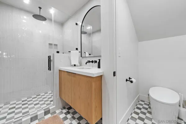 a bathroom with a sink toilet and shower