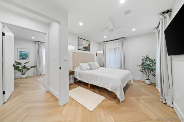 a spacious bedroom with a large bed and a flat screen tv