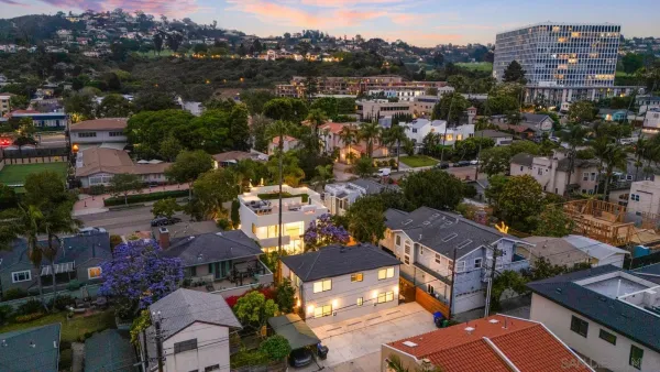 an aerial view of residential houses with outdoor space