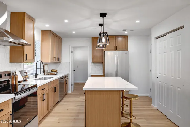 a kitchen with a sink a stove and wooden cabinets