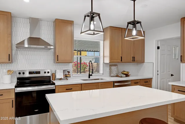 a kitchen with stainless steel appliances a sink stove and cabinets