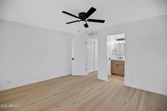 a bathroom with a tub a sink and mirror