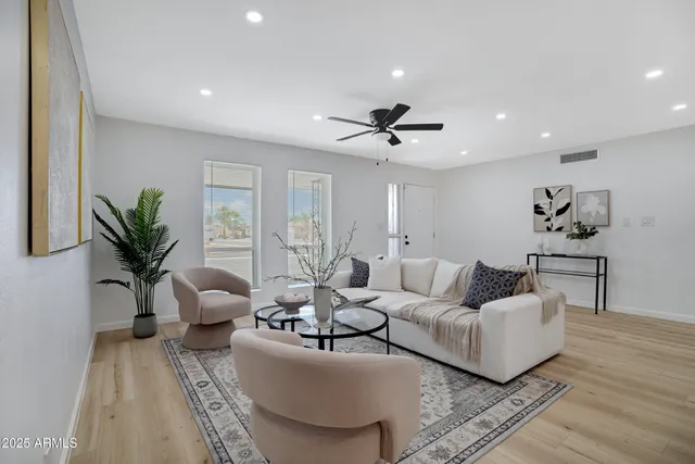 a living room with furniture and kitchen view