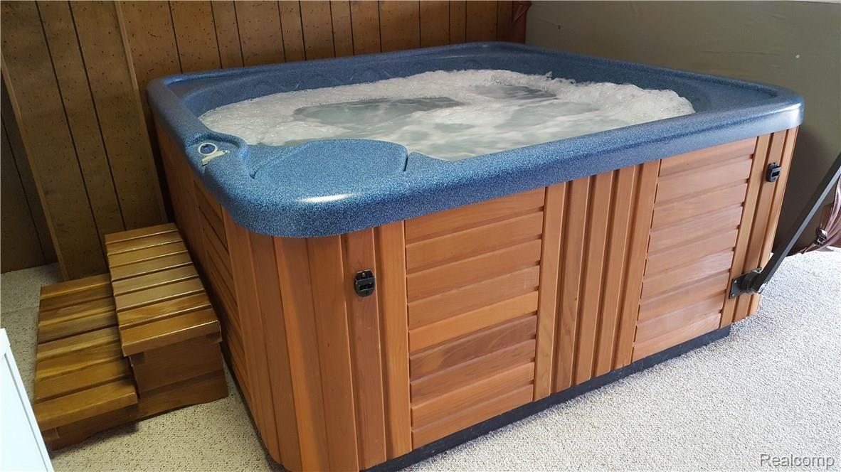 6681 Andersonville Road, Unit 28 Clarkston, MI 48346 - Photo 18 of 22 Bubbling hot tub in lower level includedfor year round enjoyment.