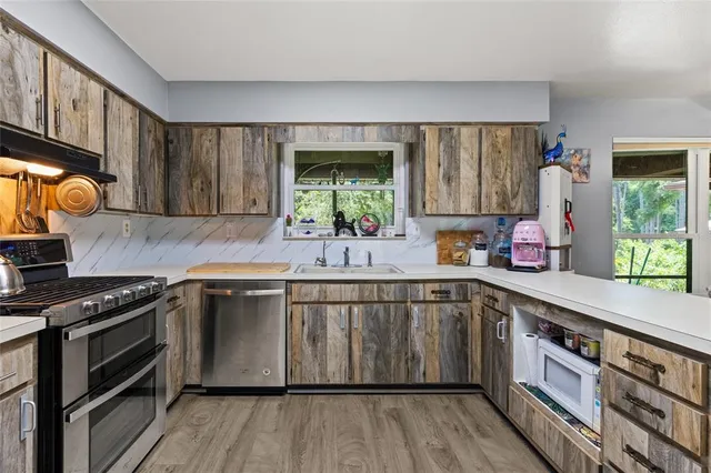 a kitchen with a sink stove and cabinets