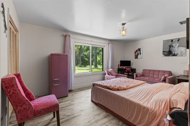 a bedroom with a bed and a chair