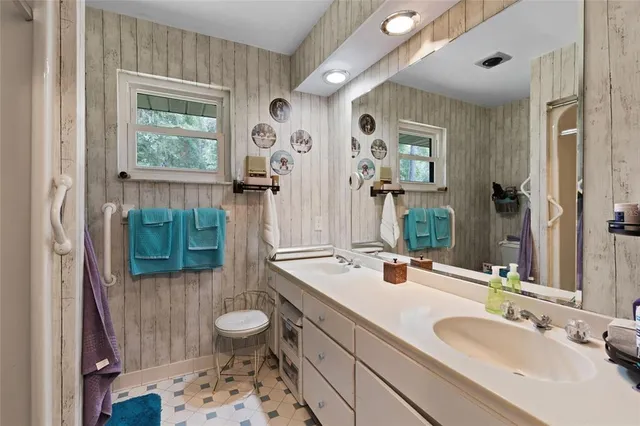 a bathroom with a sink double vanity and a mirror