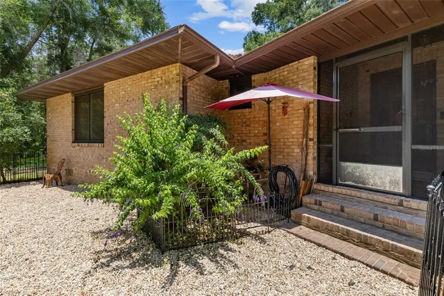 a backyard view with a seating space