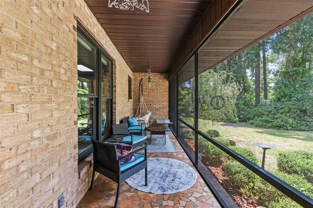a balcony with chairs and wooden floor