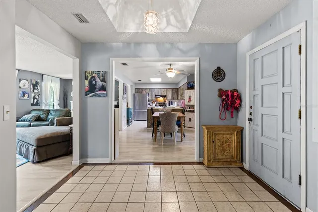 a view of a livingroom with furniture and a chandelier