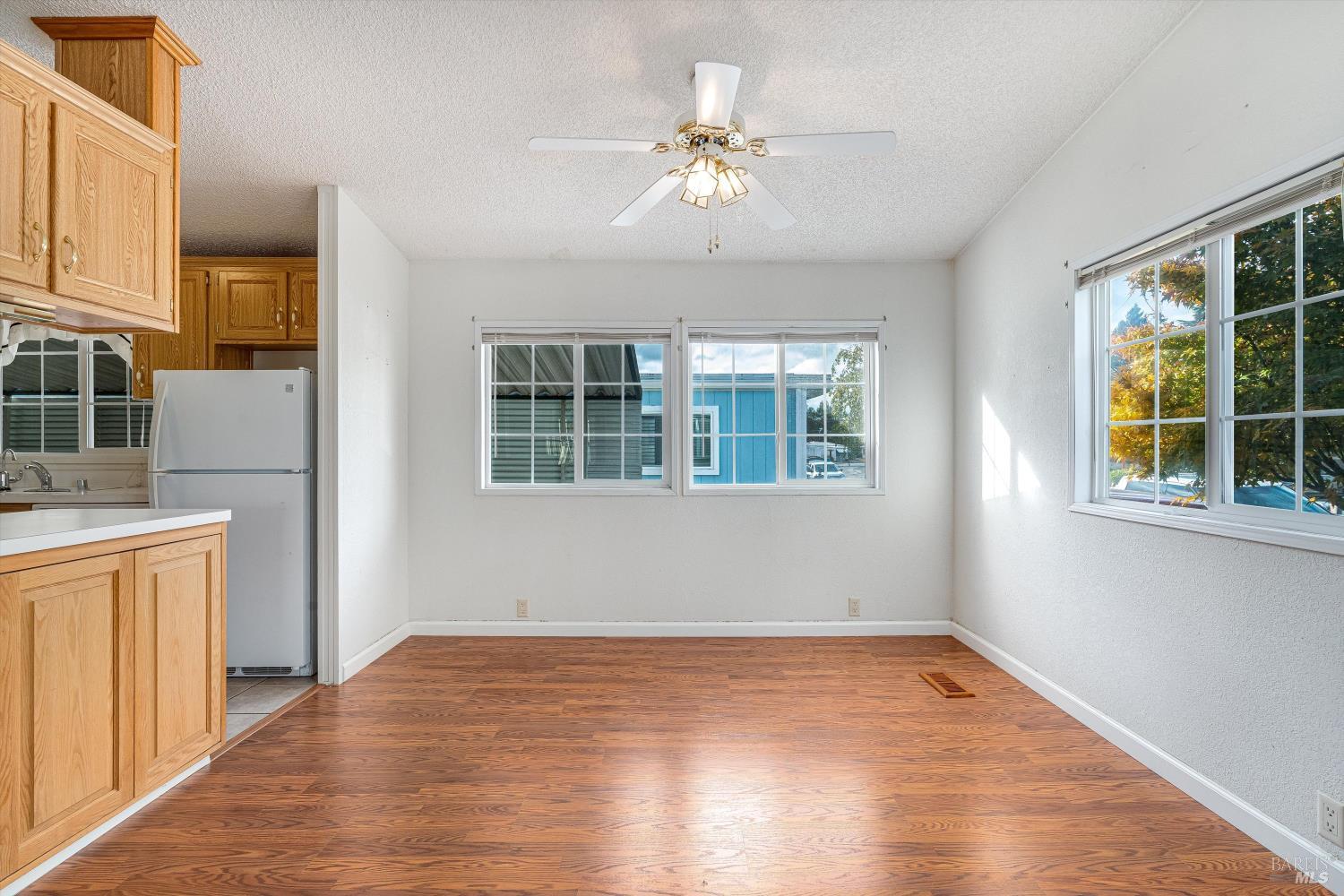 146 Westgate Circle Santa Rosa, CA 95401 - Photo 14 of 41 a view of an empty room with a window and wooden floor