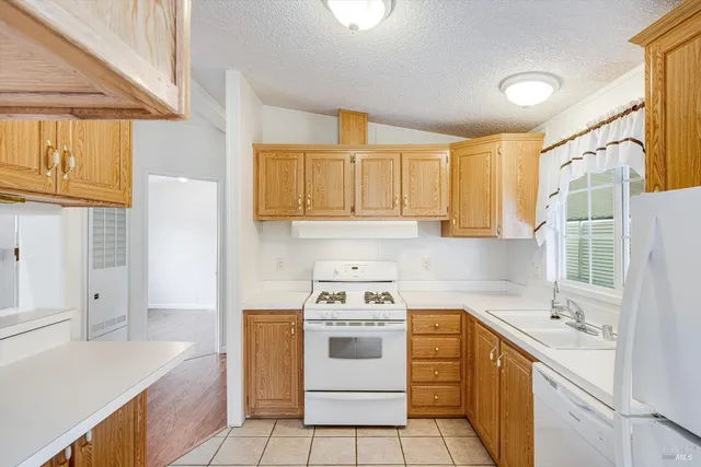 a kitchen with a stove a sink and a refrigerator