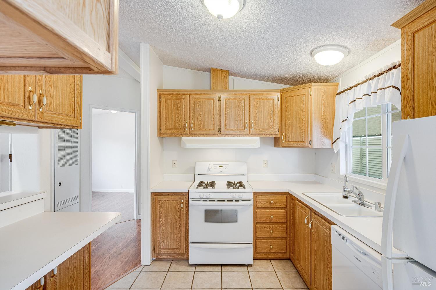 146 Westgate Circle Santa Rosa, CA 95401 - Photo 21 of 41 a kitchen with a stove a sink and a refrigerator