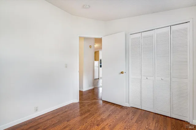 an empty room with wooden floor