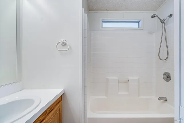 a bathroom with a bath tub with a shower