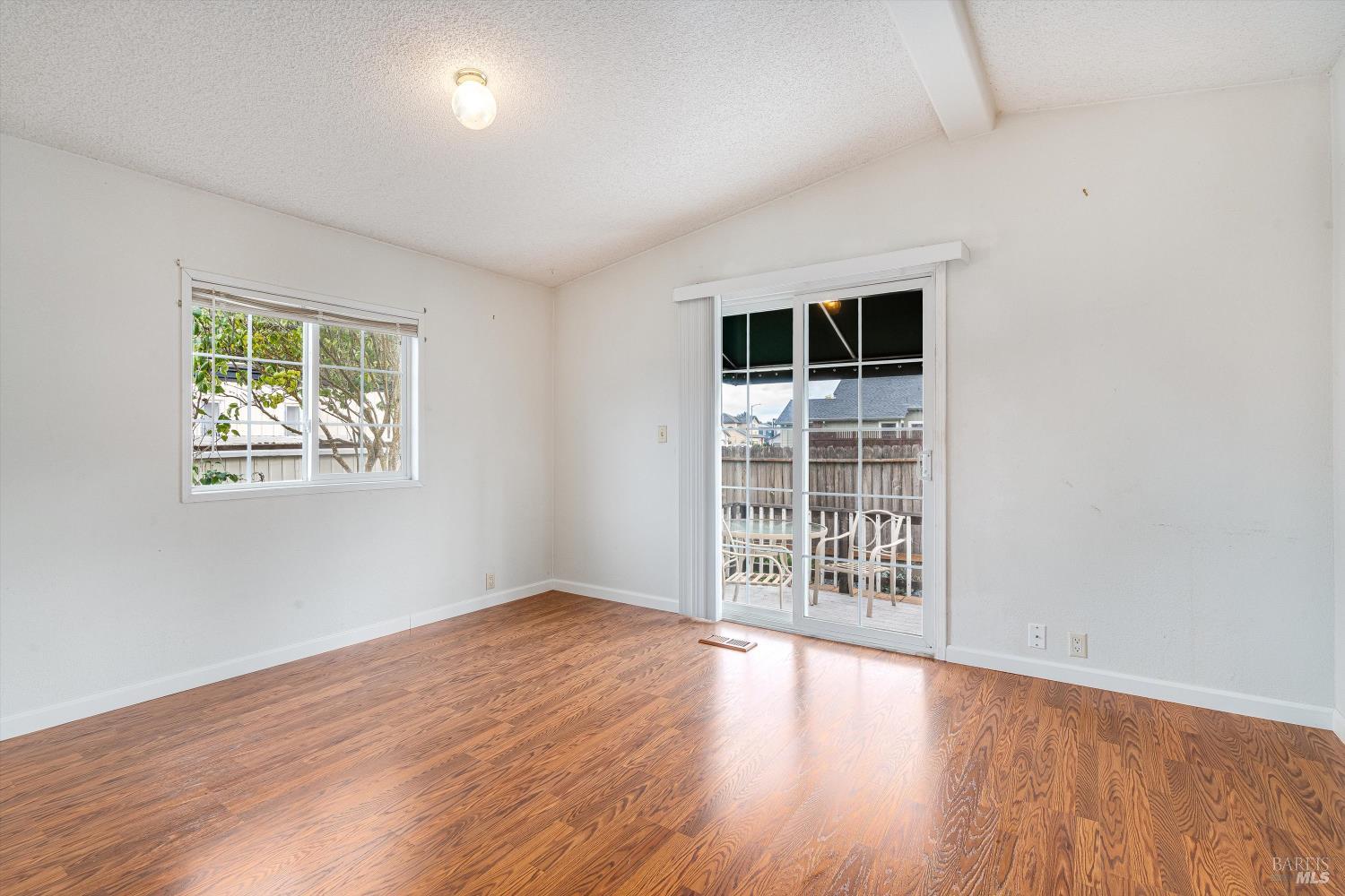 146 Westgate Circle Santa Rosa, CA 95401 - Photo 28 of 41 an empty room with wooden floor and windows
