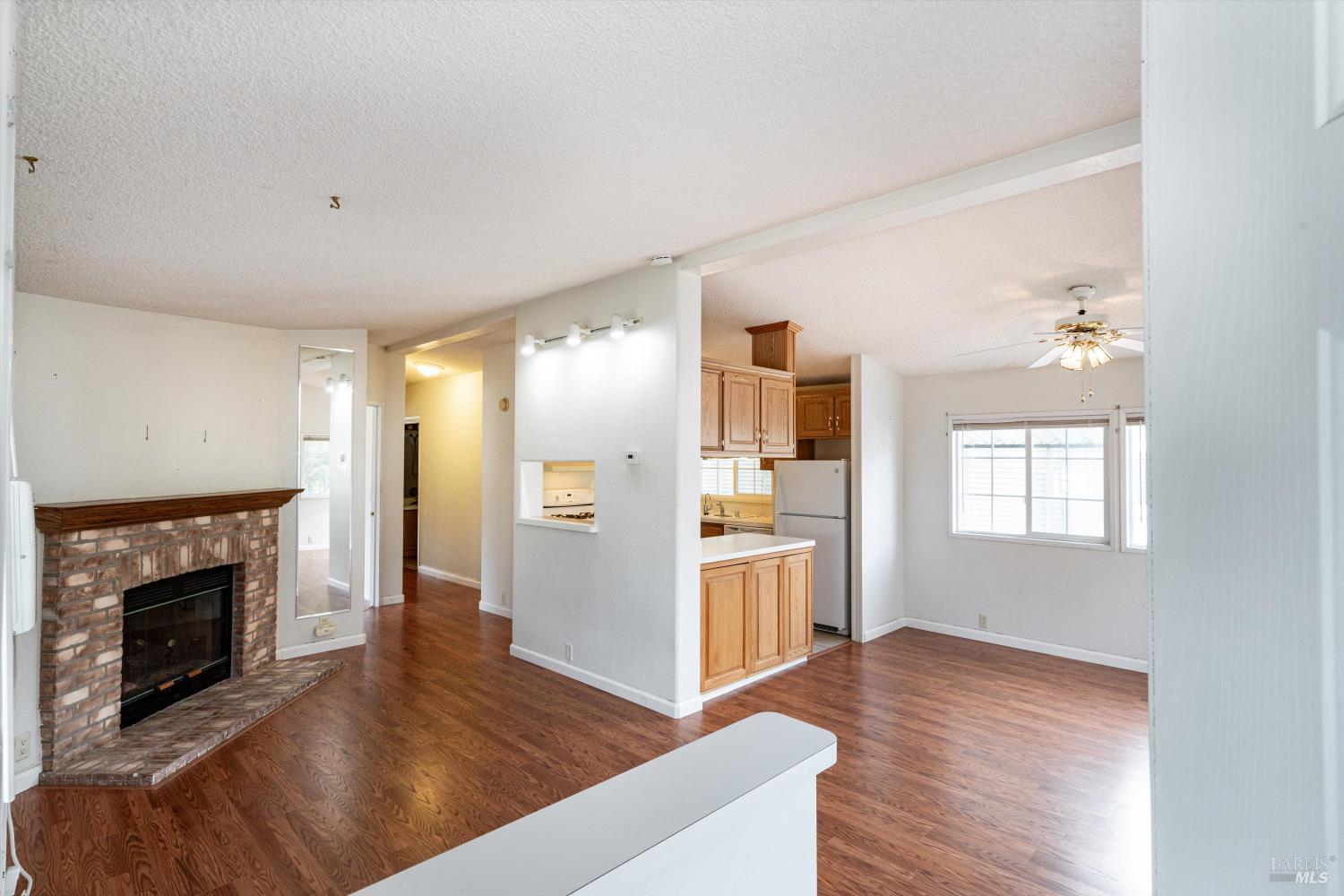 146 Westgate Circle Santa Rosa, CA 95401 - Photo 9 of 41 a living room with stainless steel appliances furniture a fireplace and wooden floor