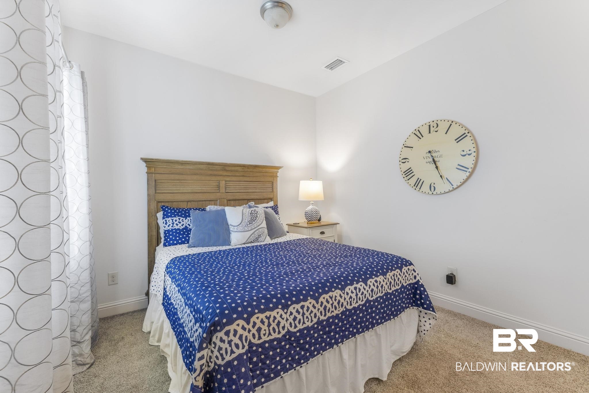 29949 Dolive Ridge Daphne, AL 36527 - Photo 30 of 55 Bedroom featuring neutral carpeting, white walls, and a light-stained wood headboard