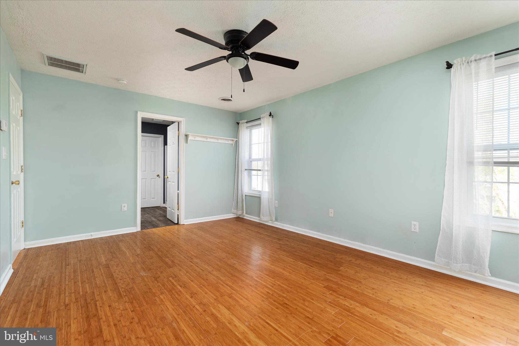 109 Fenimore Drive Inwood, WV 25428 - Photo 17 of 34 an empty room with wooden floor and windows
