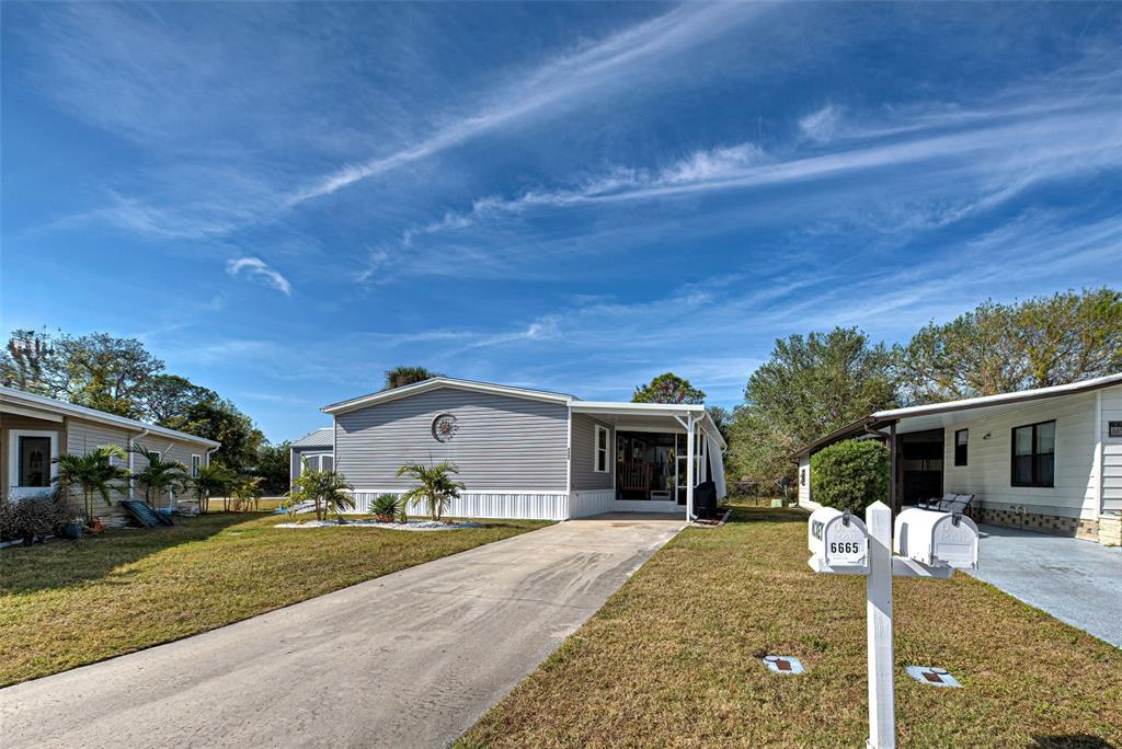 6665 Keystone Court North Port, FL 34287 - Photo 1 of 1 a front view of a house with a yard and garage