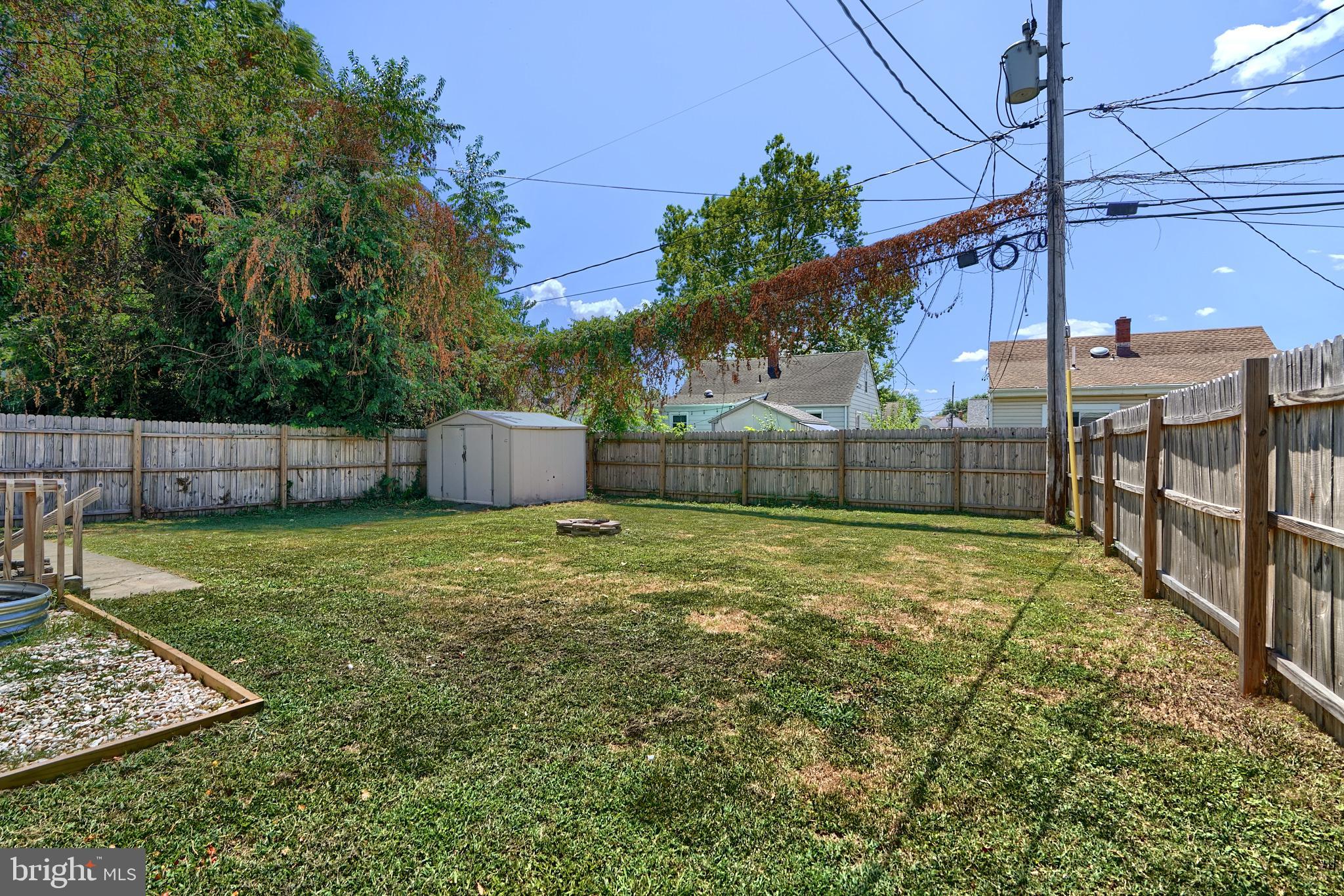 8239 Bullneck Road Dundalk, MD 21222 - Photo 32 of 35 Deck, shed , fire pit, fully privacy fenced yard