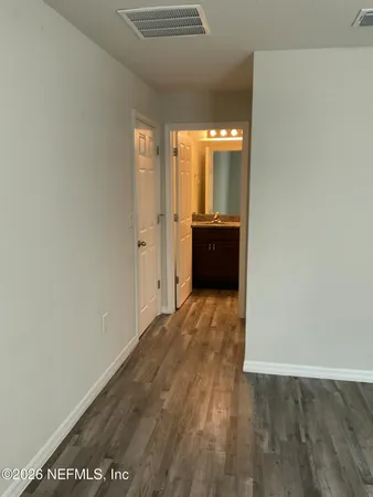 a view of a room with wooden floor