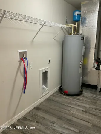 a room with water heater and wooden floor