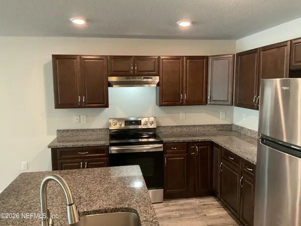 a kitchen with a stove and a refrigerator