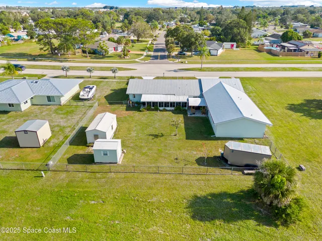 a bedroom with a bed a couch and a chandelier