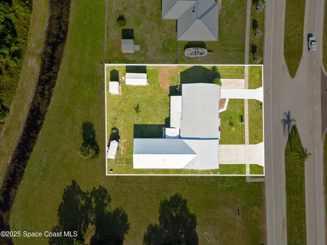 a spacious bathroom with a granite countertop sink a mirror and a bathtub