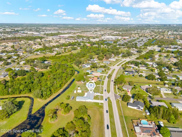 a living room with furniture and a baby crib