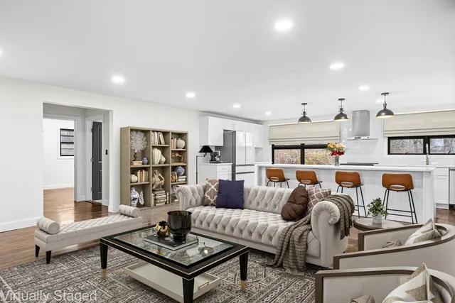 a living room with furniture and wooden floor