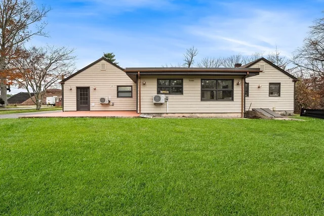 a front view of house with yard and green space