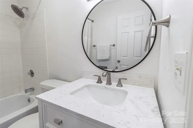 a bathroom with a sink a mirror and a bathtub