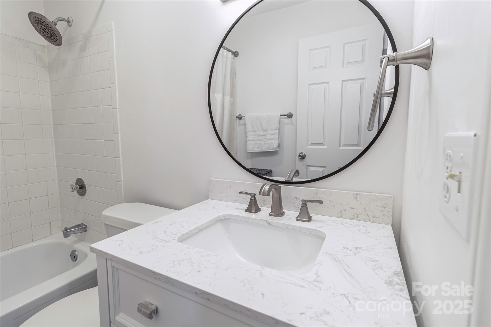 338 Orchard Trace Lane, Unit 8 Charlotte, NC 28213 - Photo 11 of 15 a bathroom with a sink a mirror and a bathtub