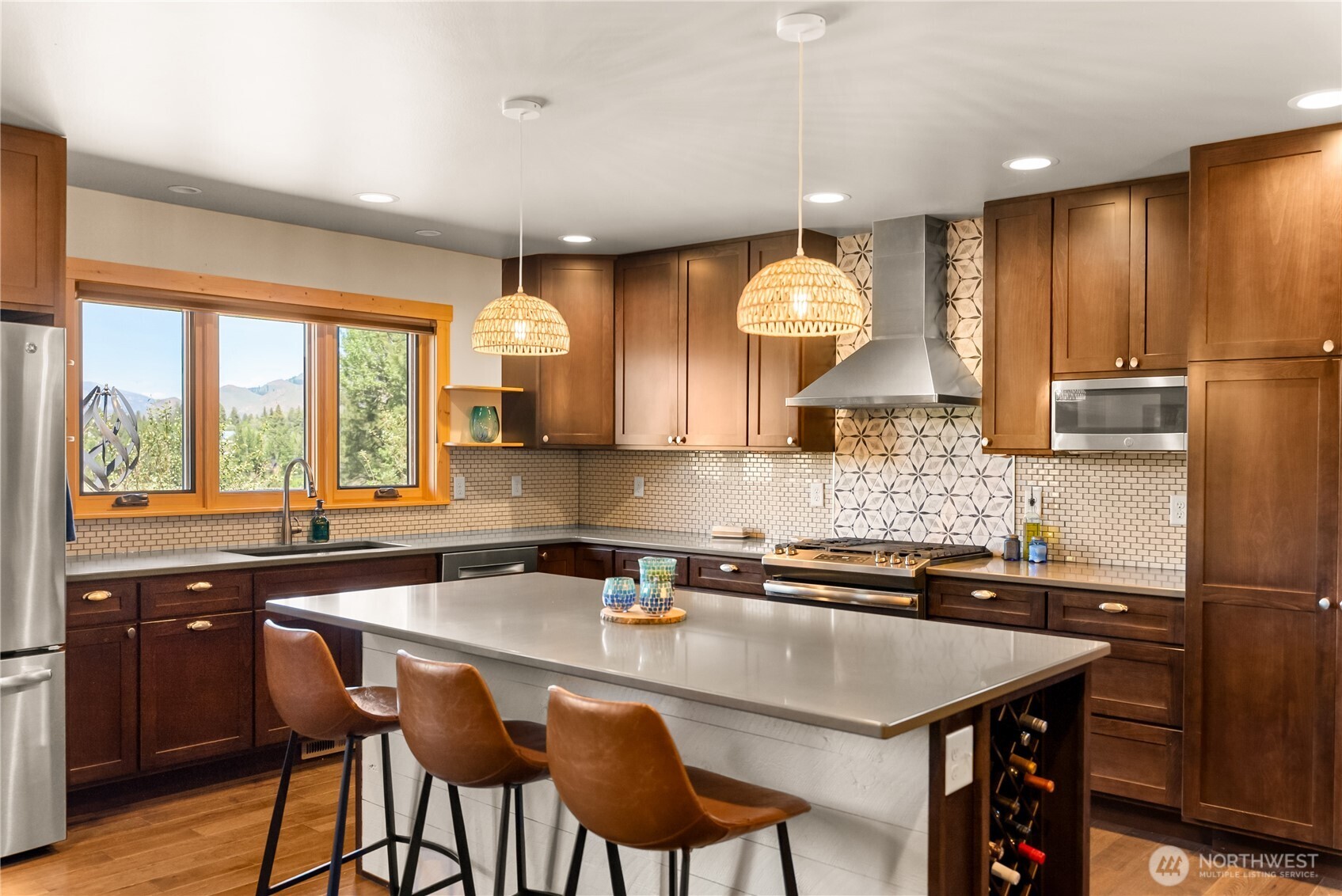 130 Sundown Road Winthrop, WA 98862 - Photo 11 of 40 a kitchen with a sink a counter cabinets and stainless steel appliances