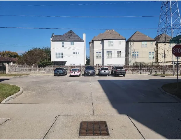 a front view of a building with large trees