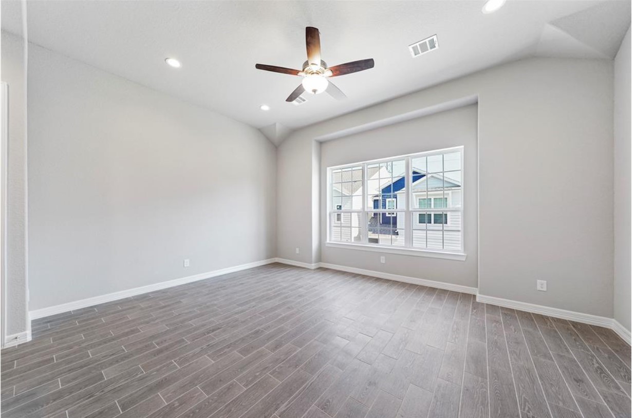 11013 Cres Light Way Houston, TX 77043 - Photo 2 of 14 wooden floor in an empty room with a window