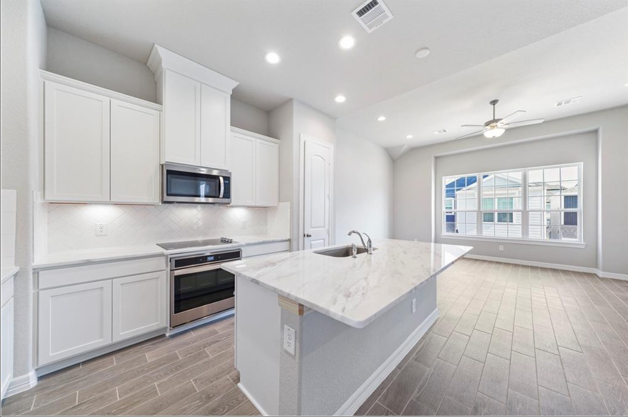 11013 Cres Light Way Houston, TX 77043 - Photo 5 of 14 a kitchen with stainless steel appliances granite countertop a sink stove and oven