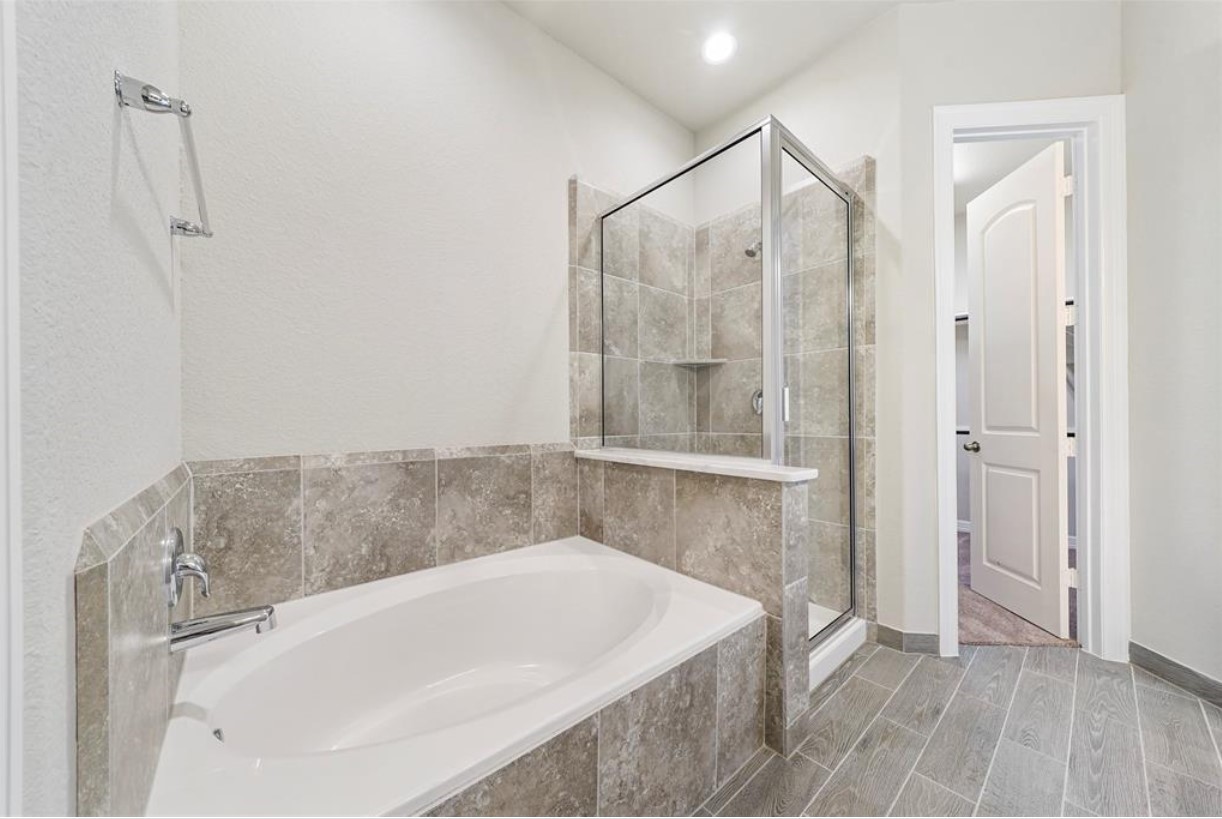 11013 Cres Light Way Houston, TX 77043 - Photo 6 of 14 a bathroom with a bathtub and a shower