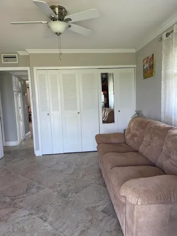 a white toilet sitting next to a bathroom sink and vanity