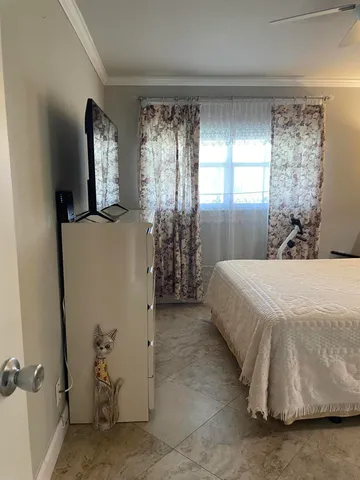 a bedroom with bed and a chandelier