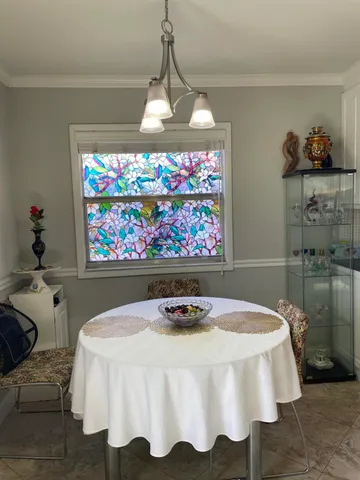 a bedroom with a bed mirror and window