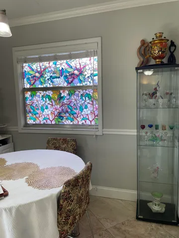 a kitchen with granite countertop white cabinets and sink