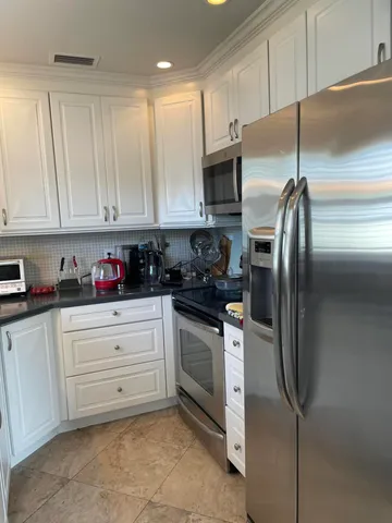 a bedroom with a bed and a lamp on the table